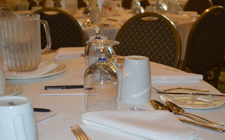 A modern conference room table with a professional speakerphone setup ready for a hybrid meeting.