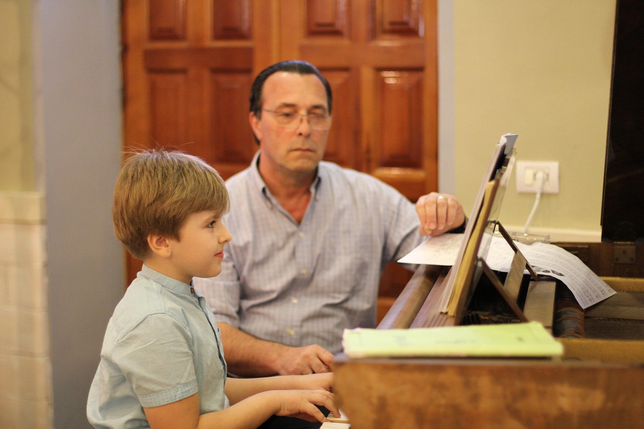 A musician testing the weighted hammer-action keys of a digital stage piano in a studio.