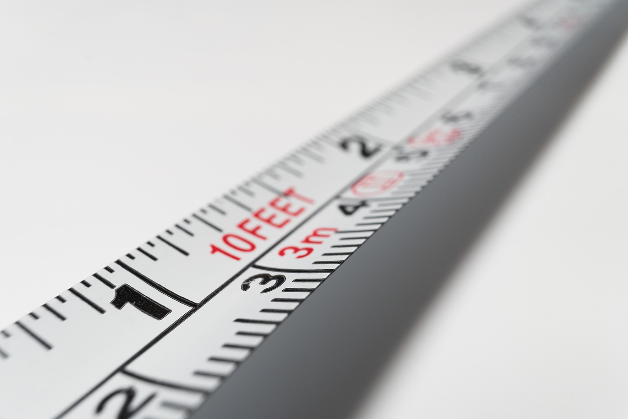 A ruler measuring a sag impression on a foam mattress surface.