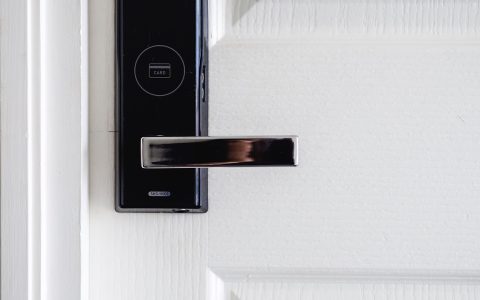A refurbished smart home security panel resting on a workbench alongside technical testing tools.