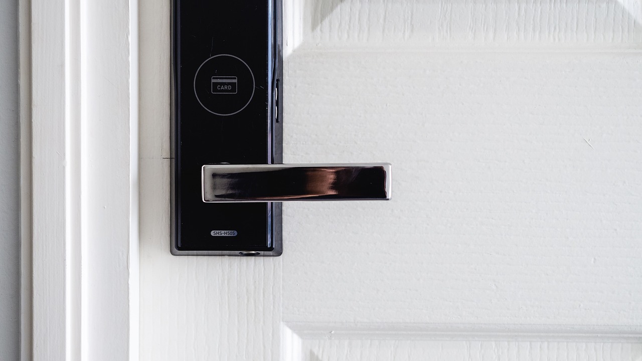 A refurbished smart home security panel resting on a workbench alongside technical testing tools.