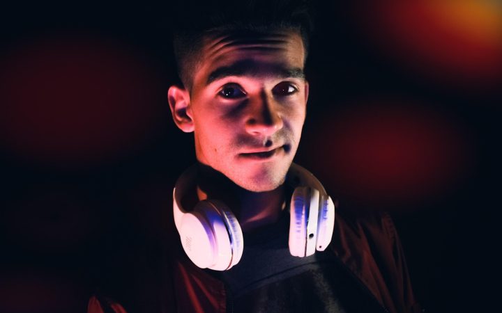 Gamer wearing a wireless gaming headset while testing audio setup at a desk