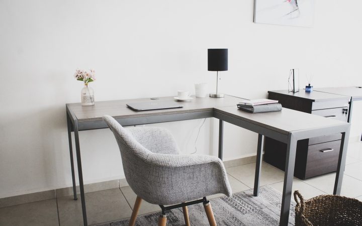 Enterprise managed network switch on a home office desk connected to a corporate laptop.