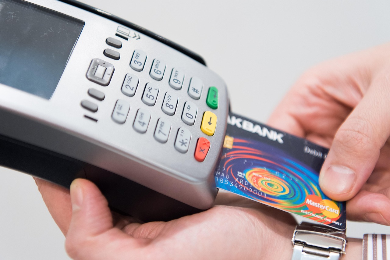 A shopper holding a credit card in a retail appliance department