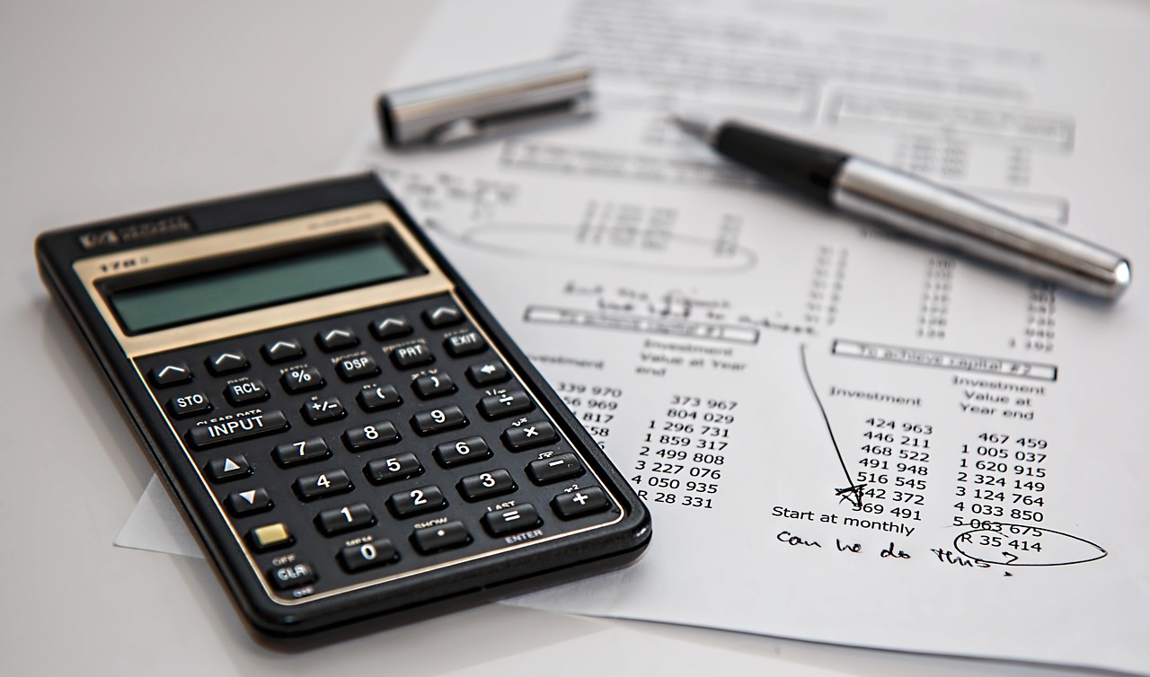 An insurance agent reviewing policy paperwork with a client across a desk.