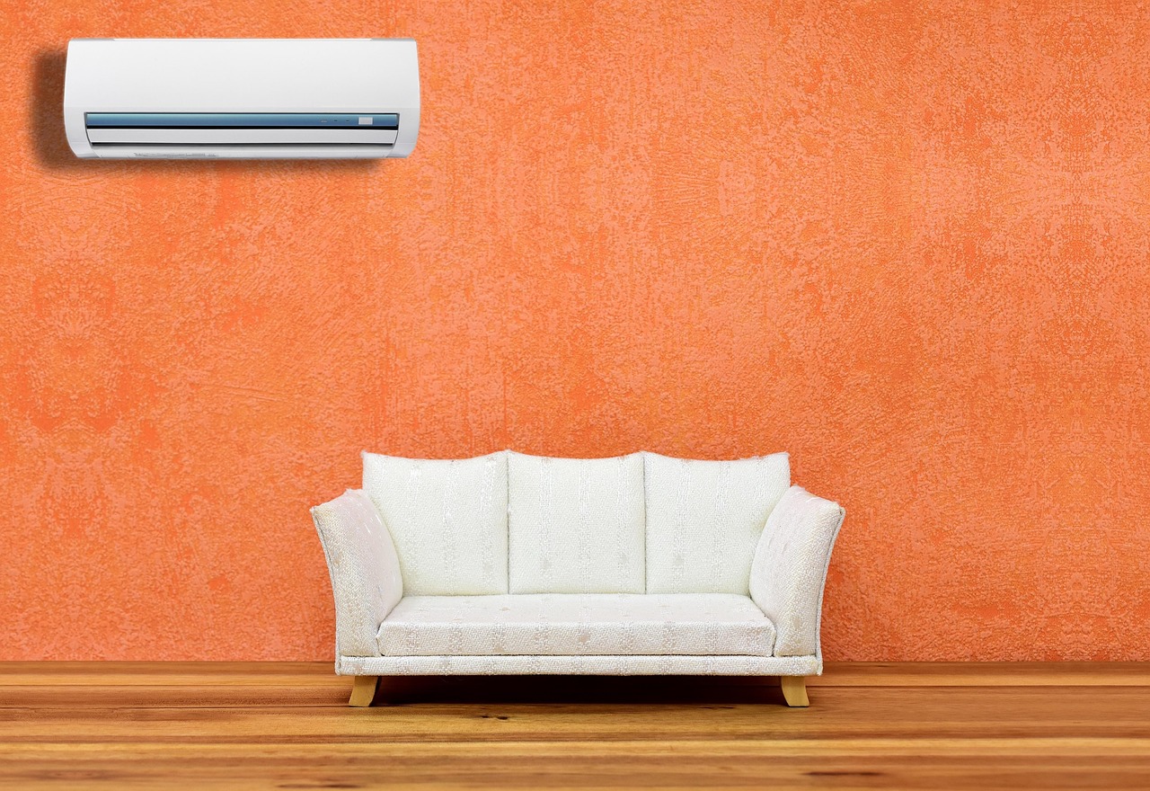 Clean outdoor air conditioning condenser unit with proper clearance and fresh copper pipe insulation.
