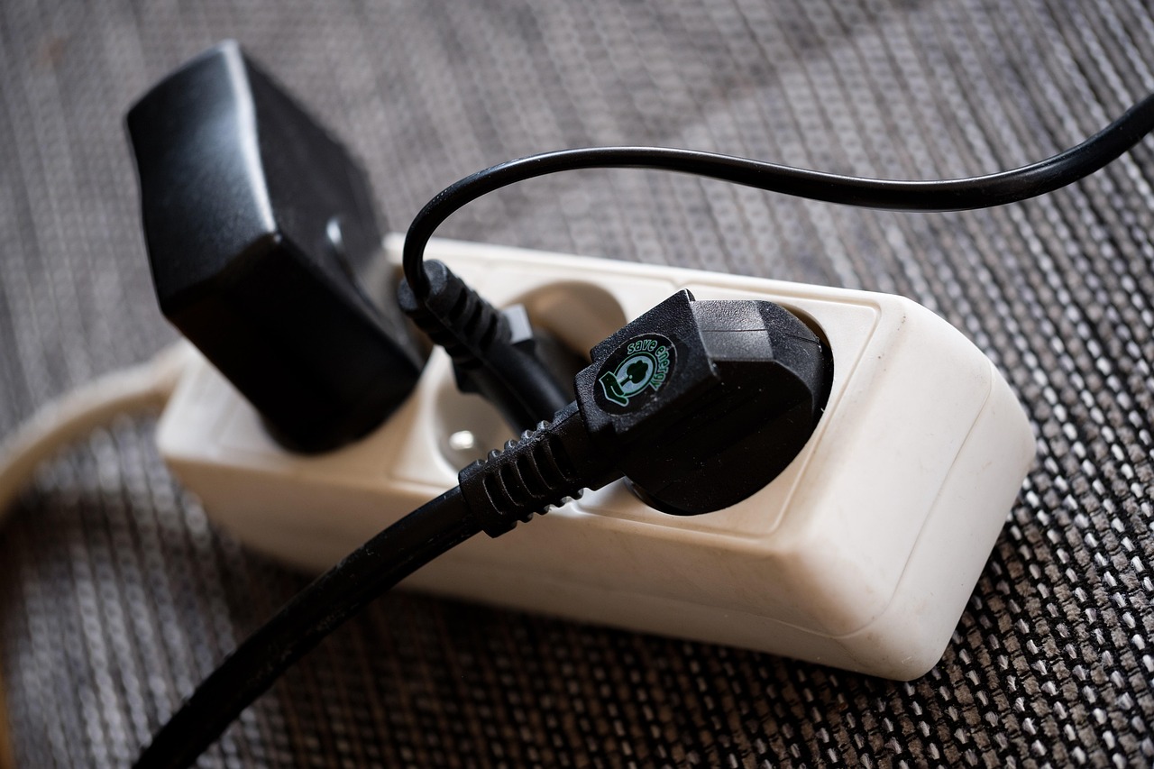 Multiple electronic cords plugged into a power strip