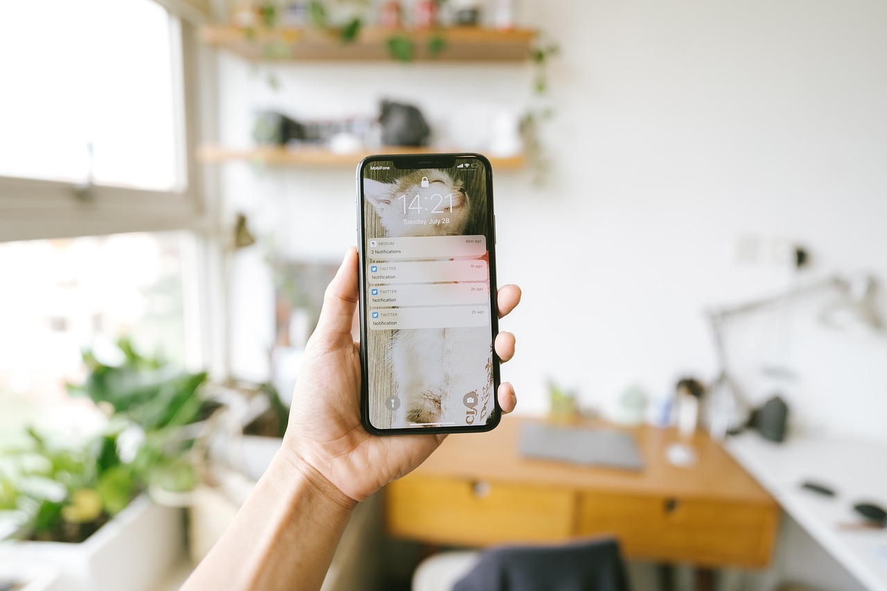 Homeowner checking smart home app notification on a smartphone.