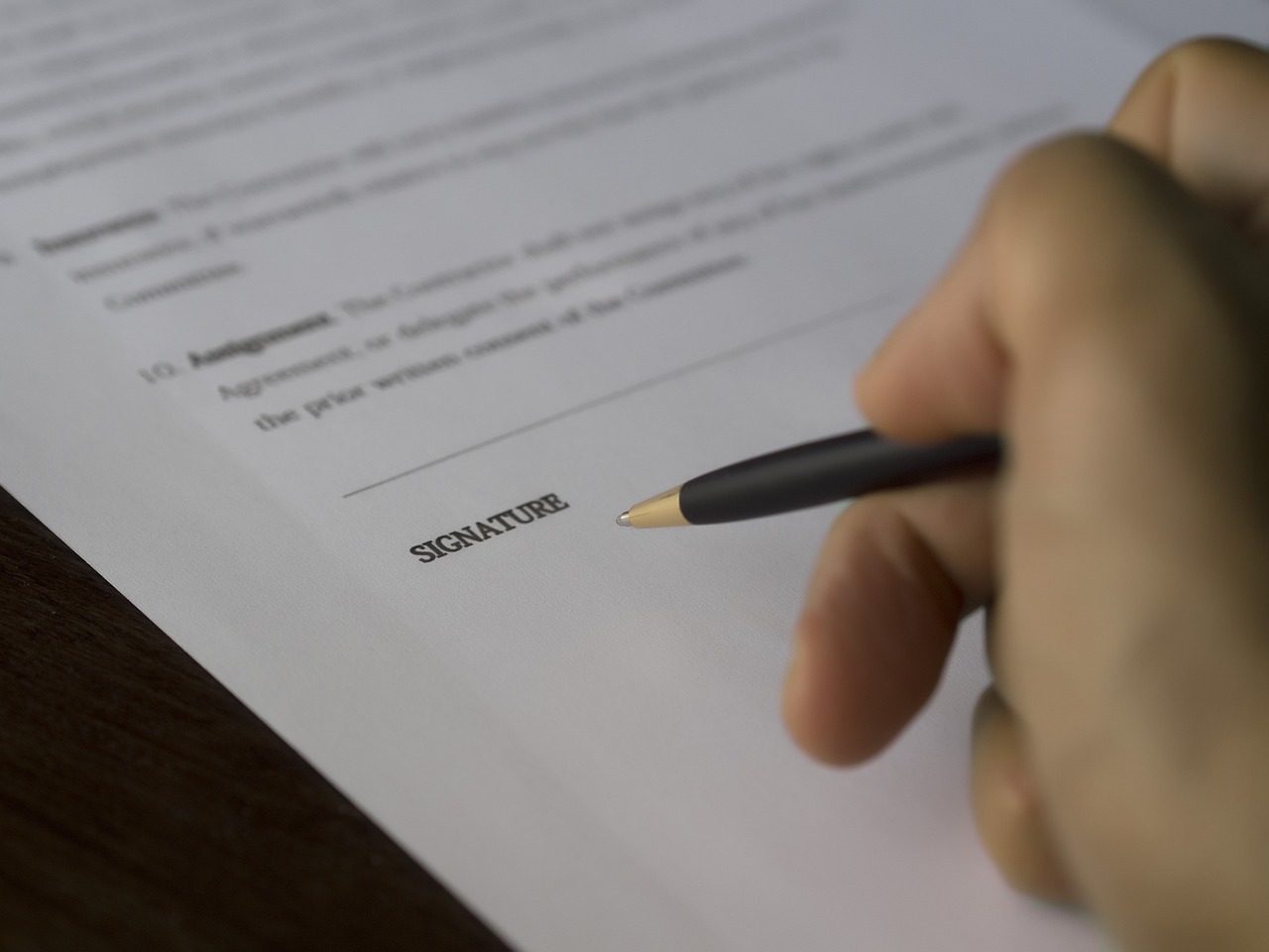 Financial documents, contract paperwork, and a tablet displaying residential energy analysis.