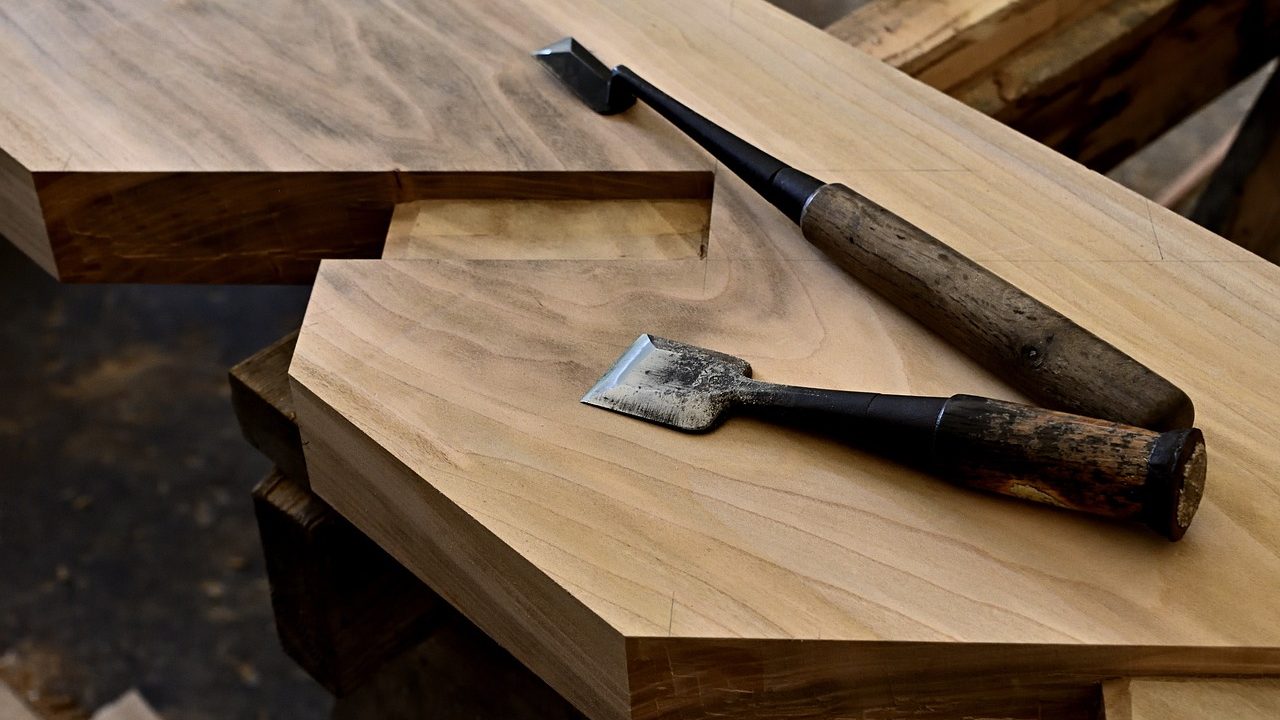 Close-up of a carpenter installing a wooden handrail on a staircase
