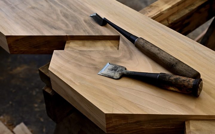 Close-up of a carpenter installing a wooden handrail on a staircase