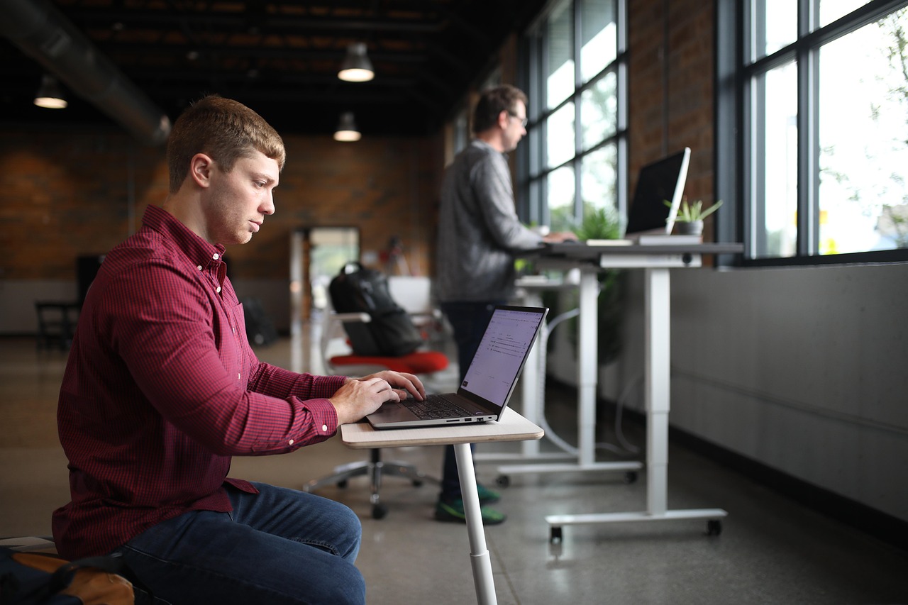 A two-tier desktop standing desk converter positioned on an existing surface.