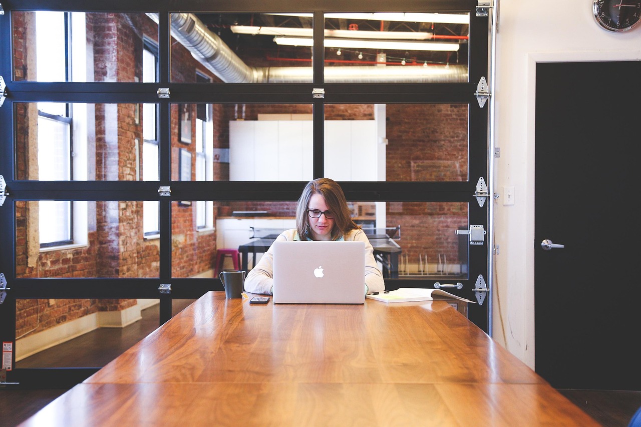 Two professionals discussing employee benefit options in a modern corporate office.