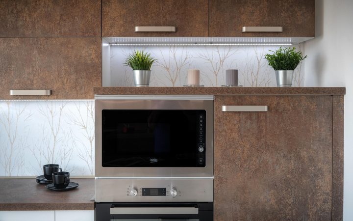 Sleek stainless steel built-in wall oven installed in a modern kitchen cabinetry setup.