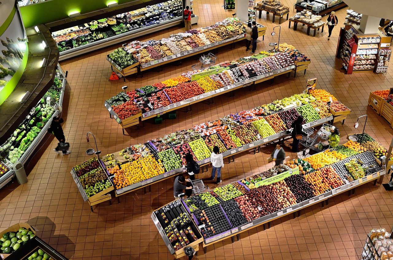 Fresh dairy and refrigerated goods displayed in a supermarket cooler.