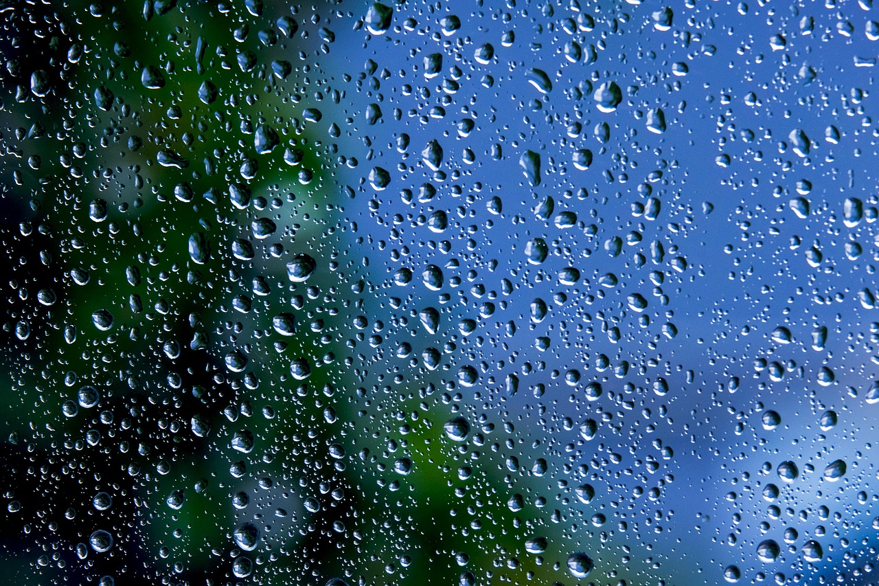 Close-up of a worker sealing a storm door glass insert into a frame.