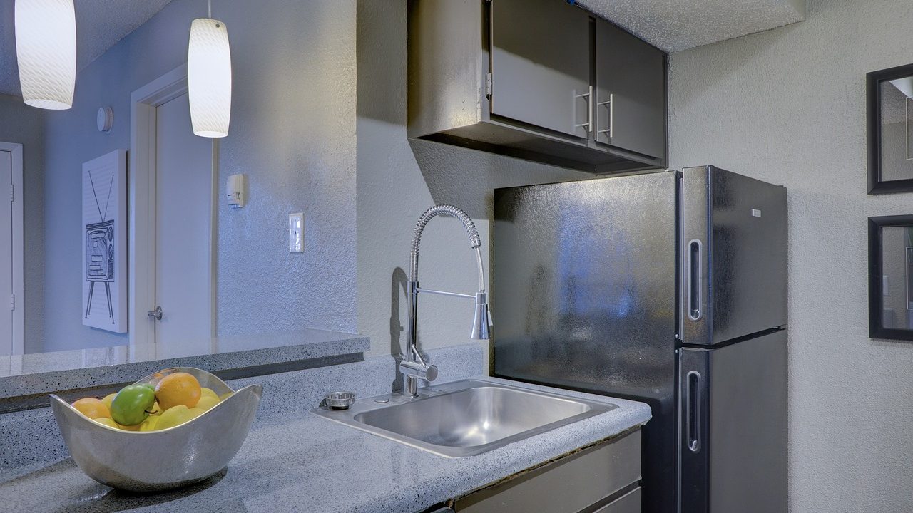 Modern stainless steel refrigerator in a newly remodeled residential kitchen.