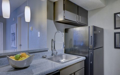 Modern stainless steel refrigerator in a newly remodeled residential kitchen.