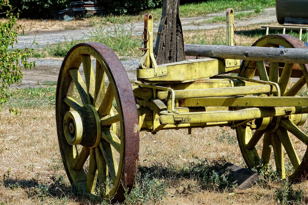 A mechanic inspecting the leaf springs and axle of a utility trailer.