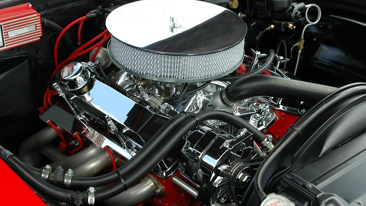 Mechanic inspecting the engine bay of a hybrid vehicle