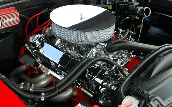 Mechanic inspecting the engine bay of a hybrid vehicle
