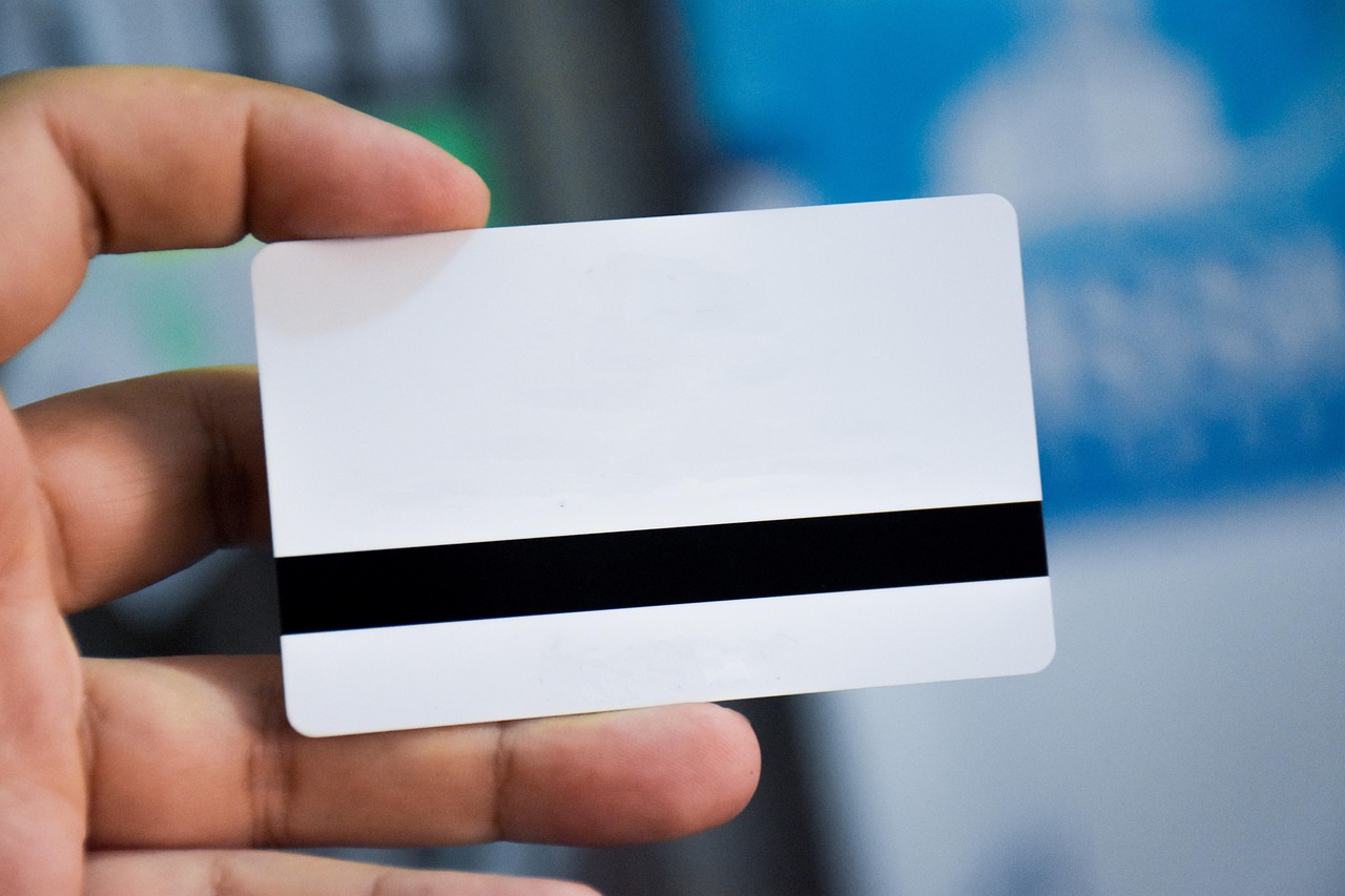 Official identification cards and a passport placed next to a tablet displaying secure identity verification software.