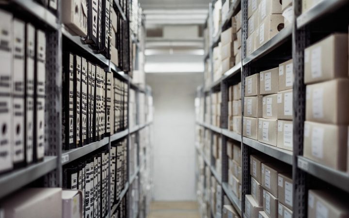 A modern warehouse club optical display featuring neatly organized eyeglass frames on bright glass shelves.