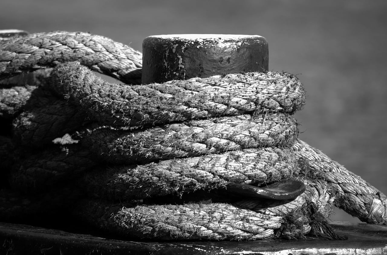 Side-by-side comparison of a cracked black rubber hose and a new braided steel washing machine line.