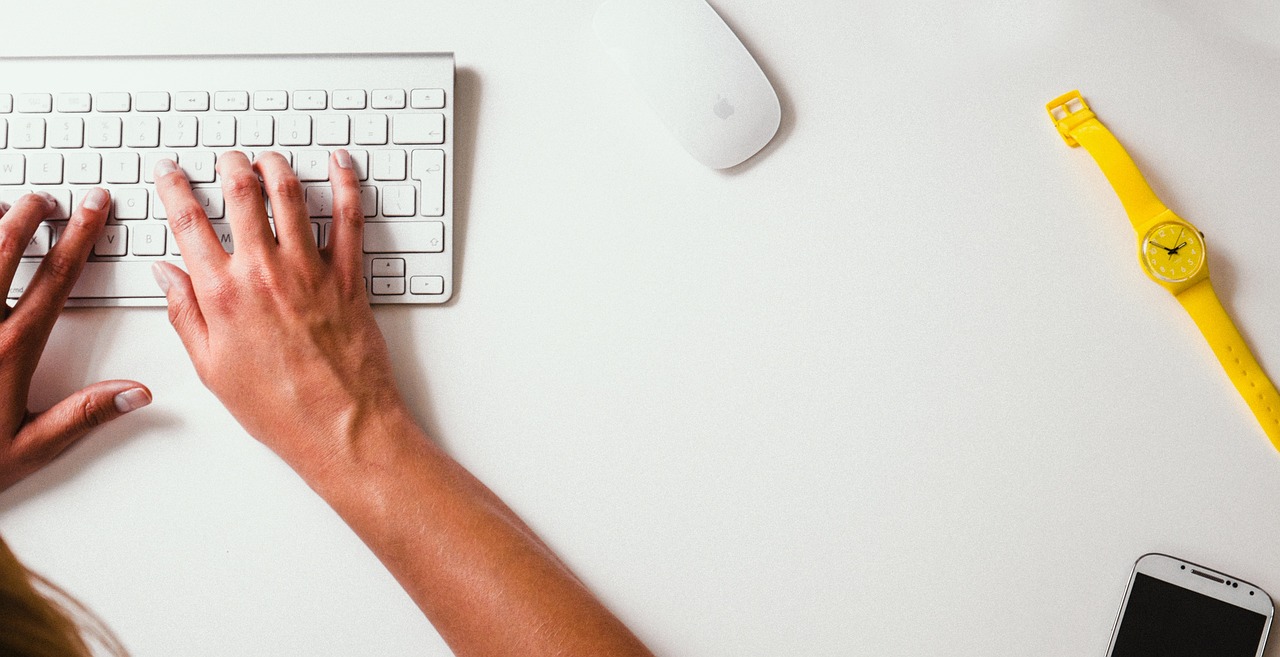 Close-up of hands typing on a mechanical keyboard during a work session