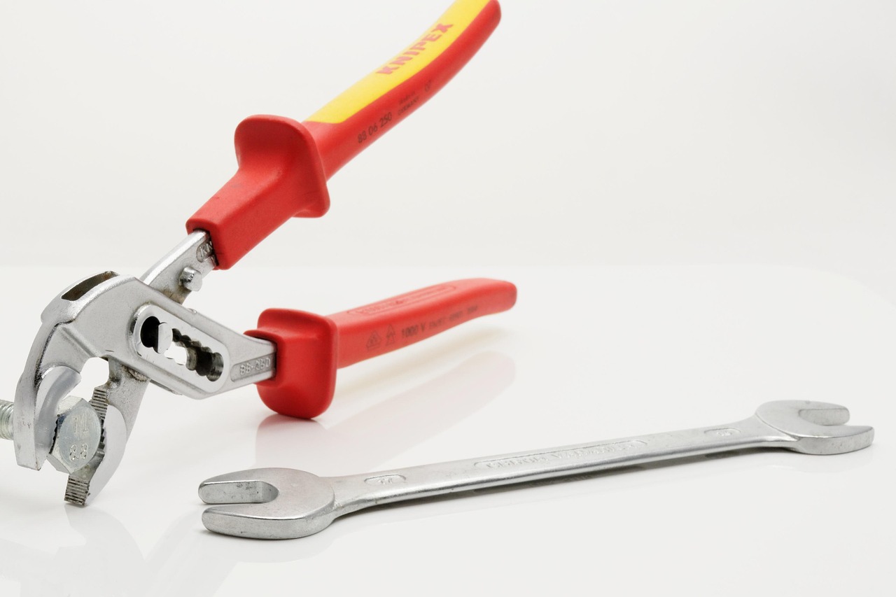 Close-up of hands using a filter wrench on a water filter housing