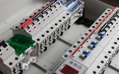 Electrician inspecting a residential electrical service panel