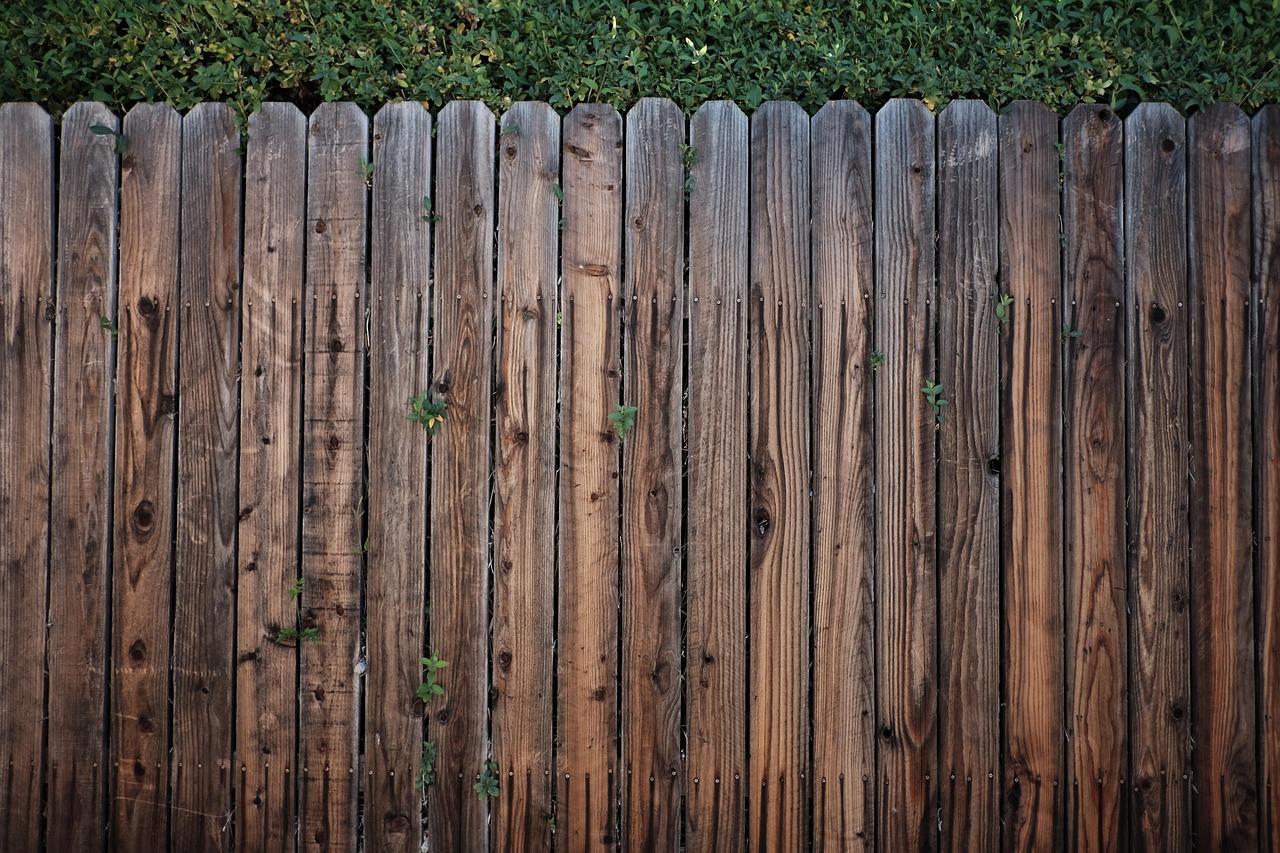 A newly installed low-maintenance vinyl privacy fence with clean structural footings.