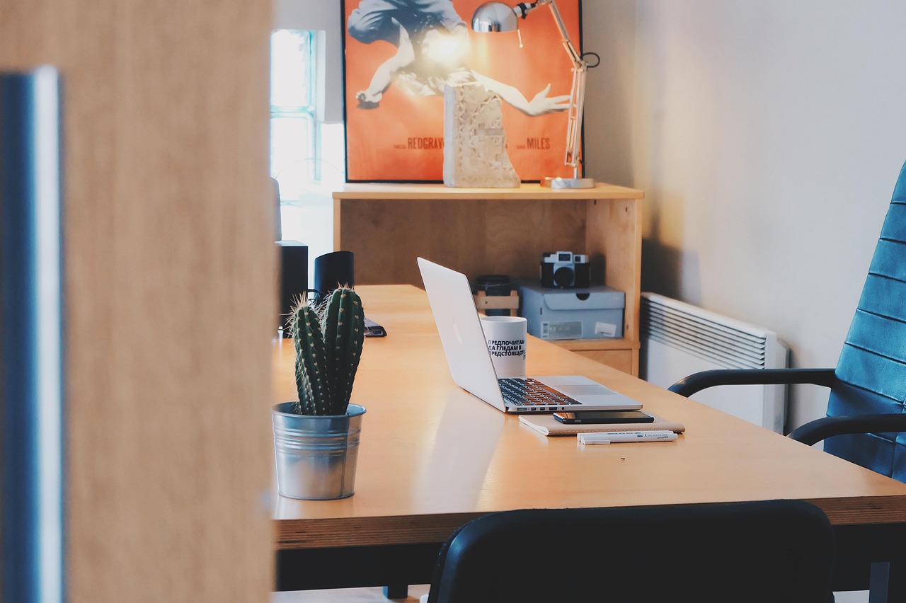 An employee working productively at an ergonomically adjusted workstation in an open office.
