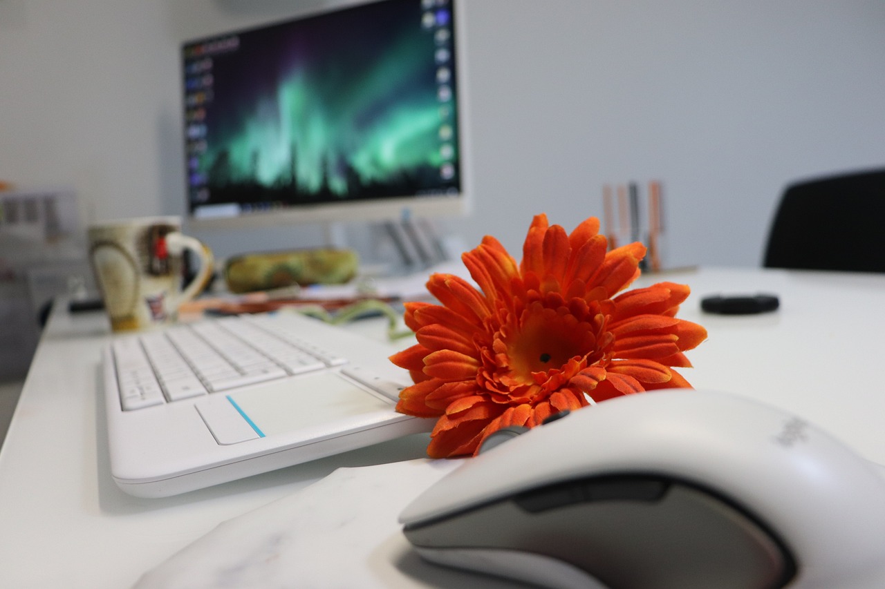 Remote worker reviewing documents and computer security settings at a home workspace.