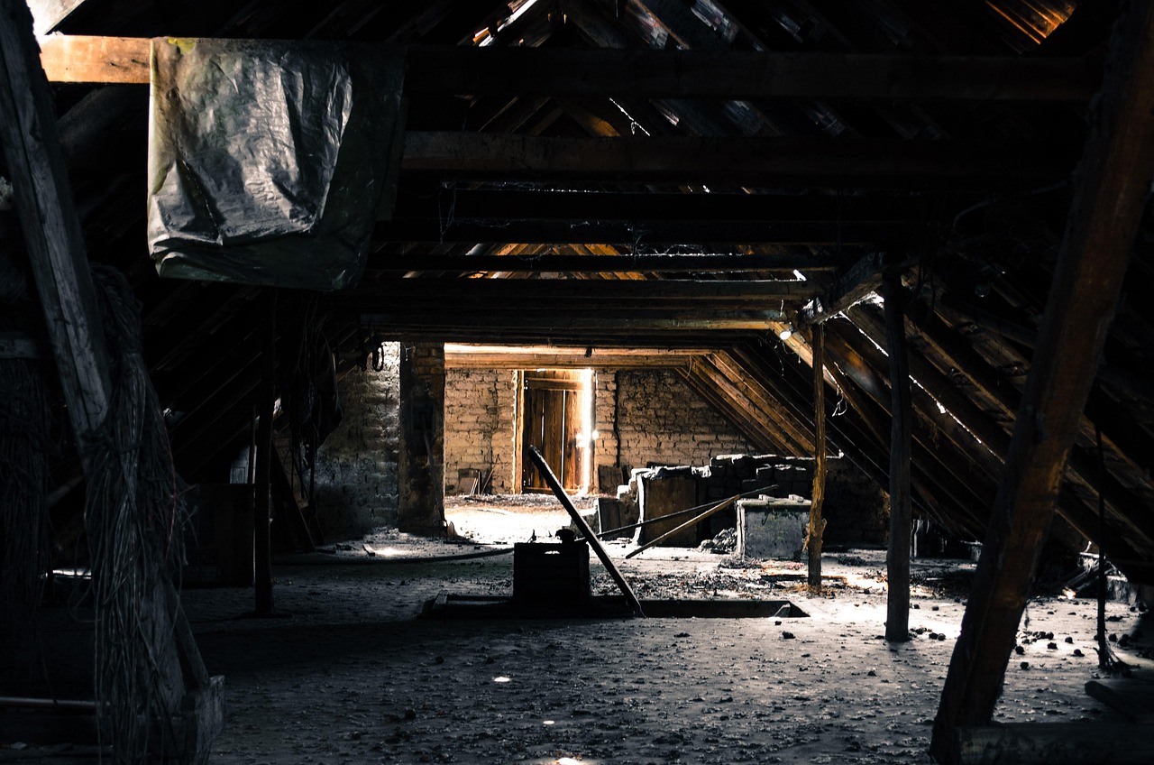 Exposed metal HVAC ductwork running through an unconditioned attic