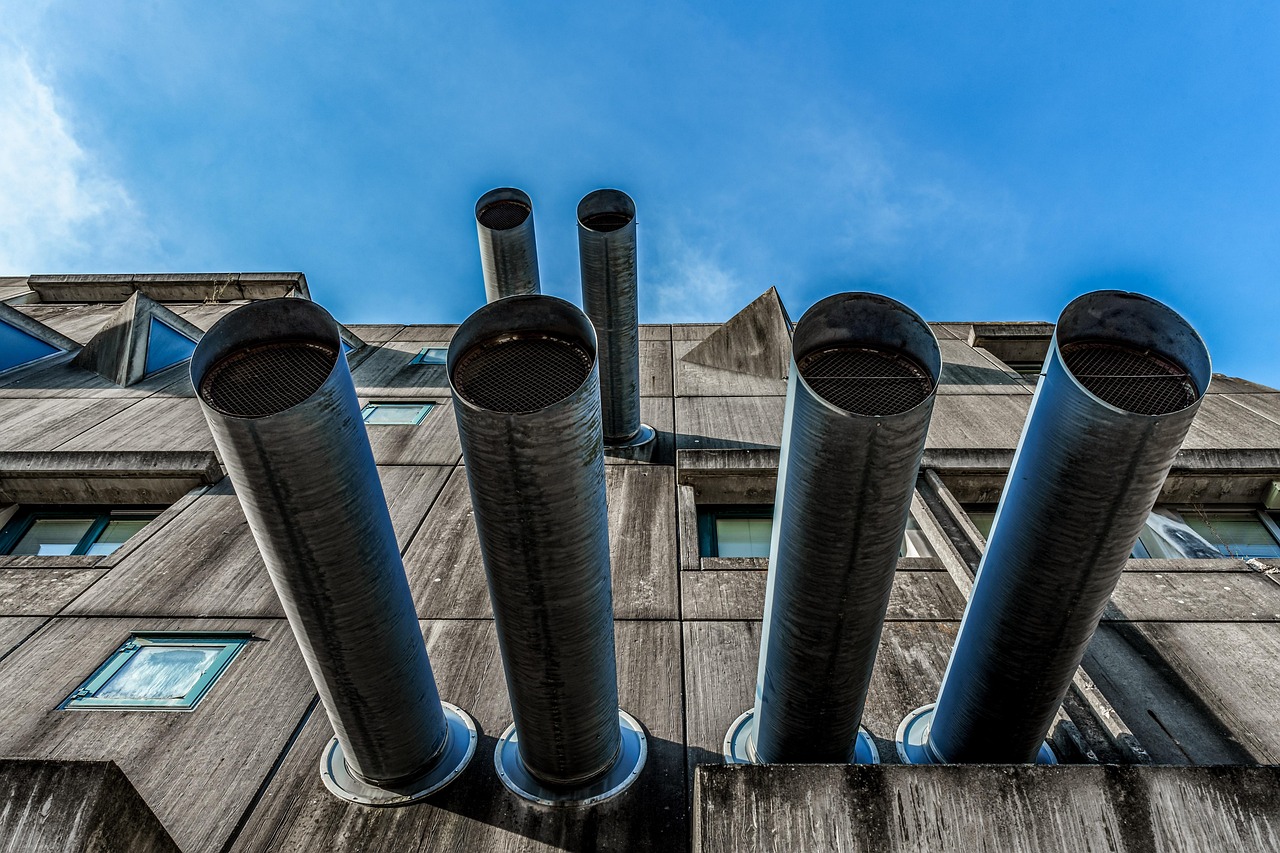Close-up view of residential attic insulation and ventilation structures.