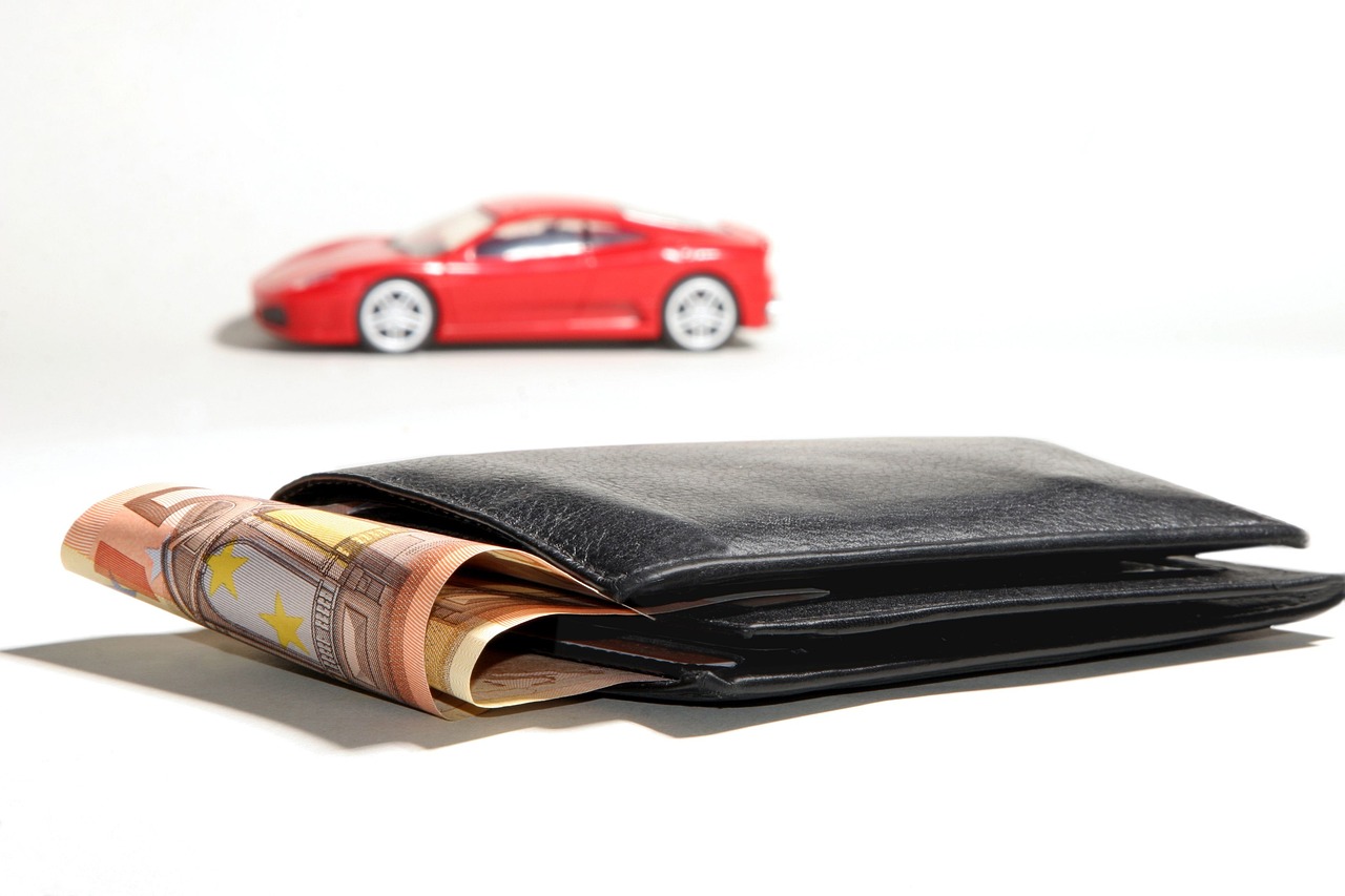A car buyer reviewing documents at a dealership or bank desk.
