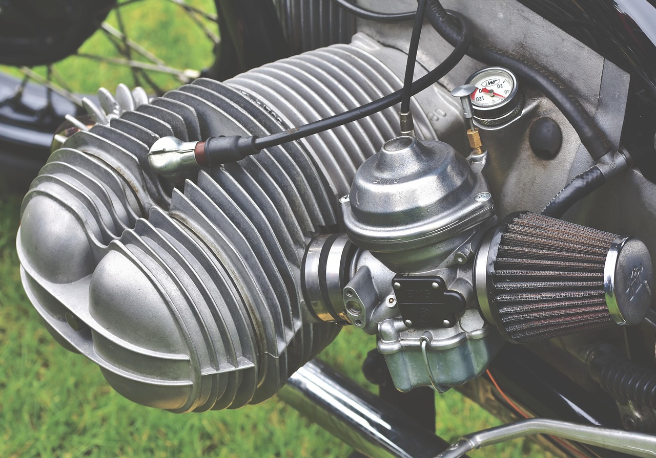 Mechanic working on a small engine carburetor and fuel lines
