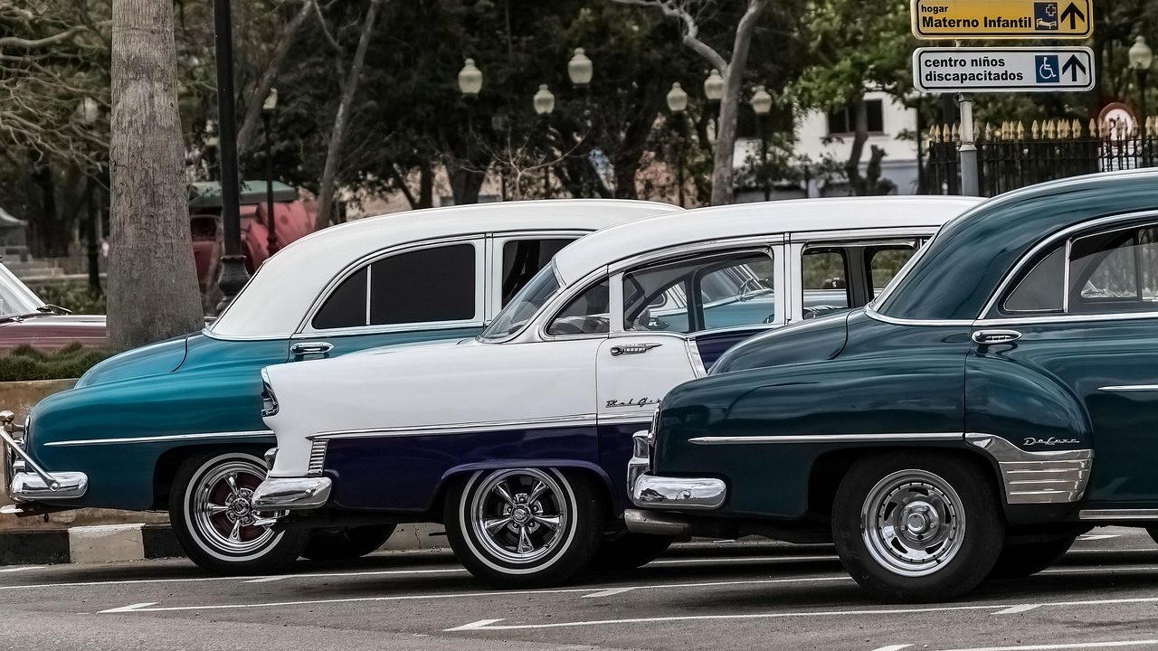 Rows of cars parked in a secured municipal vehicle impound lot.