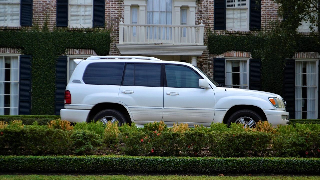 A utility trailer parked in a residential driveway ready for loading.