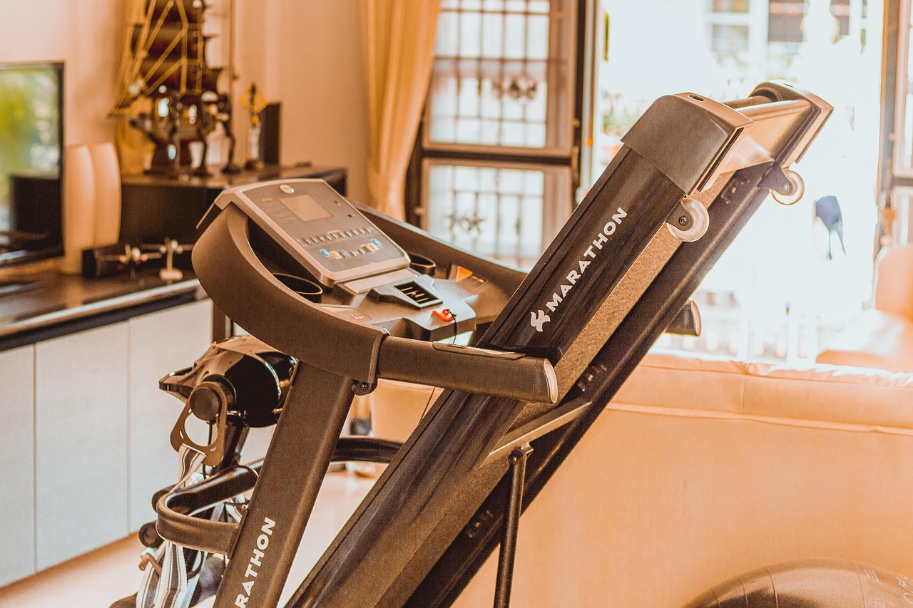 A digital tablet mounted on exercise equipment displaying workout metrics.