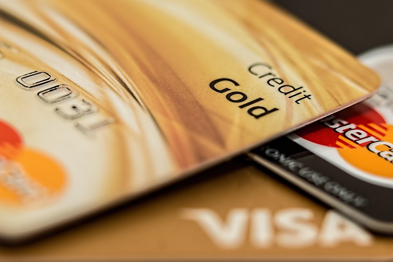 Person reviewing bills and credit card statements at a desk.