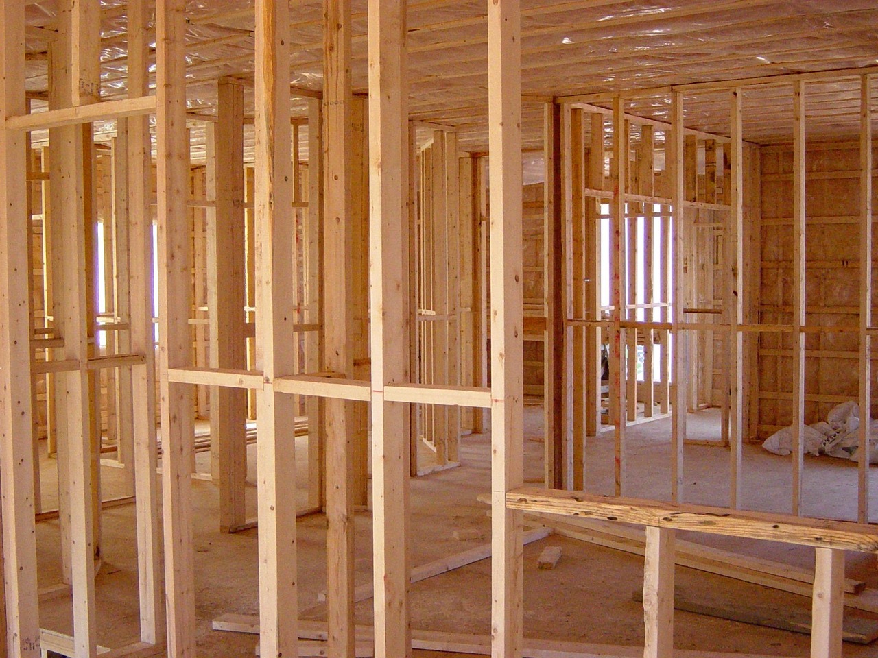 A construction contractor framing the walls of a new backyard workshop outbuilding.