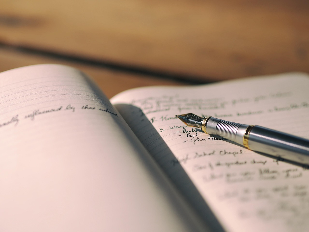 A focused professional writing daily tasks in a simple paper journal.