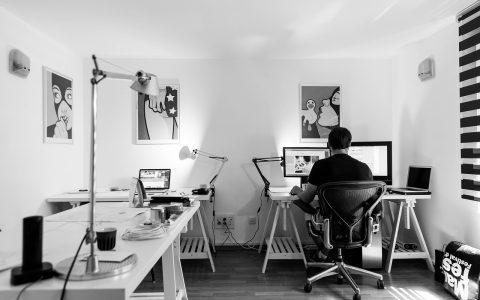 Clean home office desk with dual laptop setup and external monitor