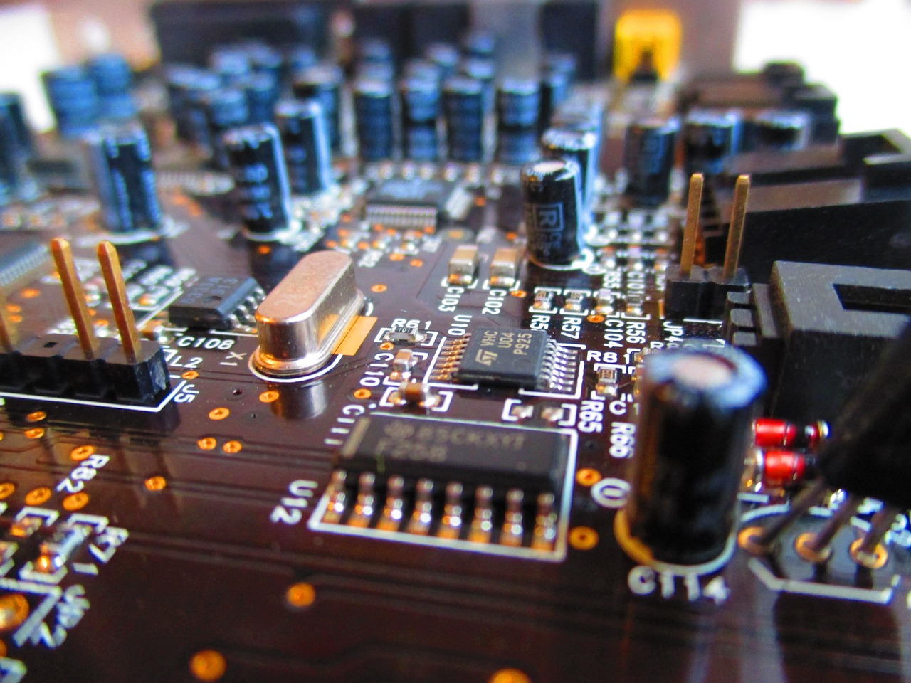 Electrician testing a circuit board with a multimeter.
