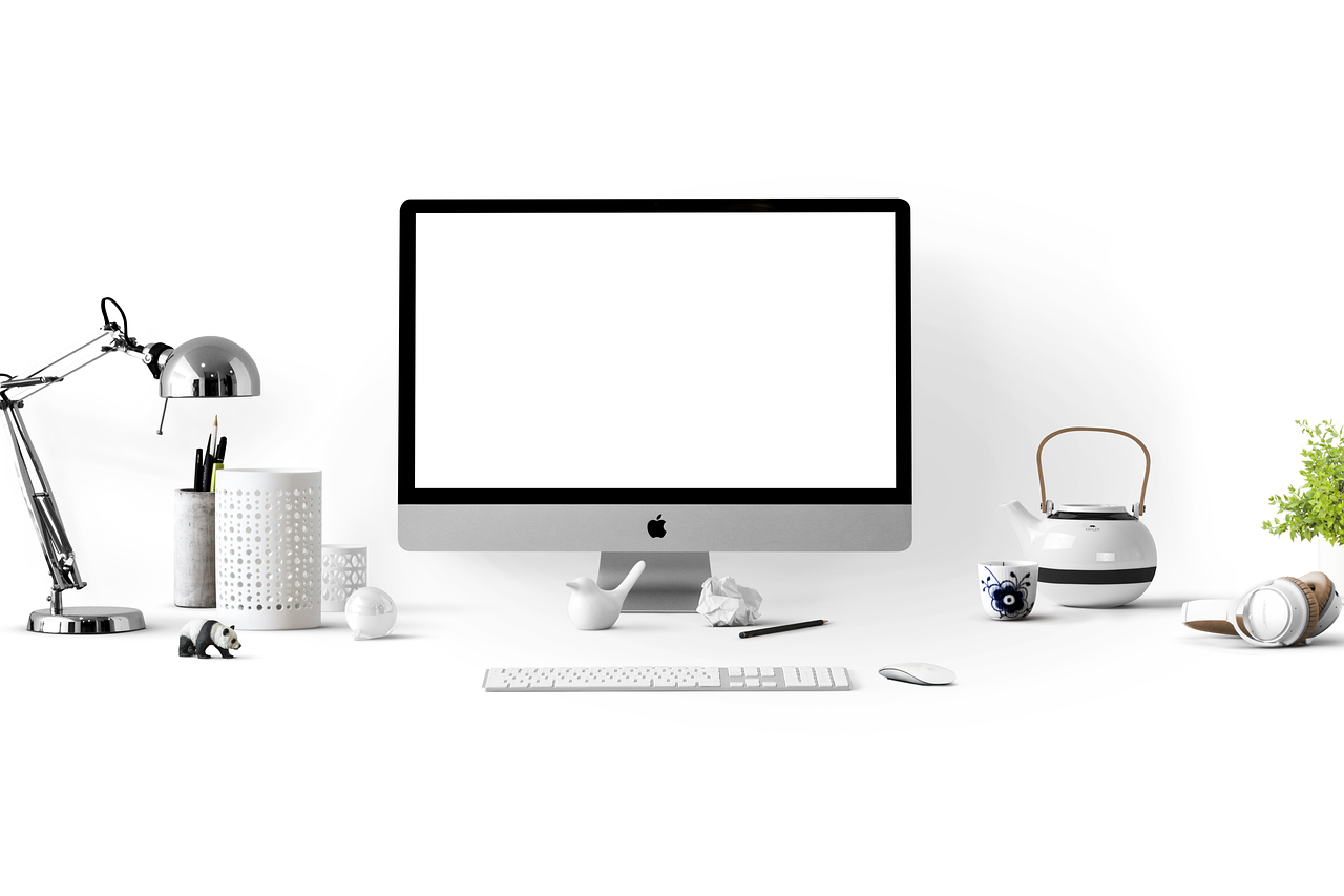 Close-up of an external webcam securely attached to the top bezel of a desktop monitor.