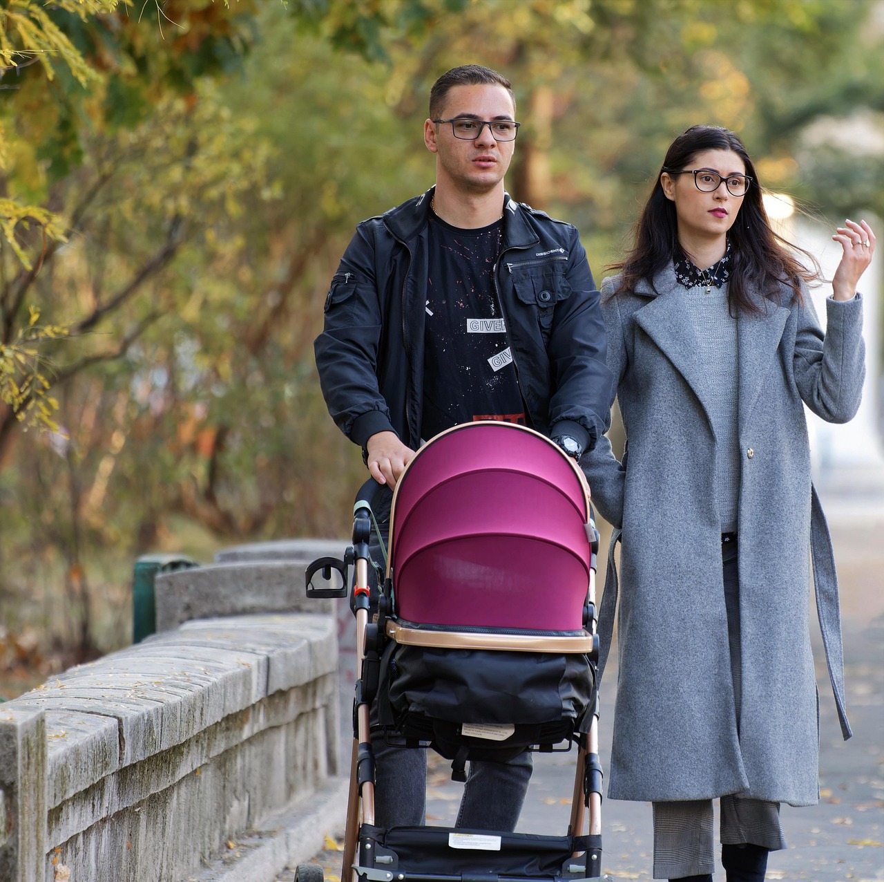 Family walking together down a sunny urban sidewalk during vacation