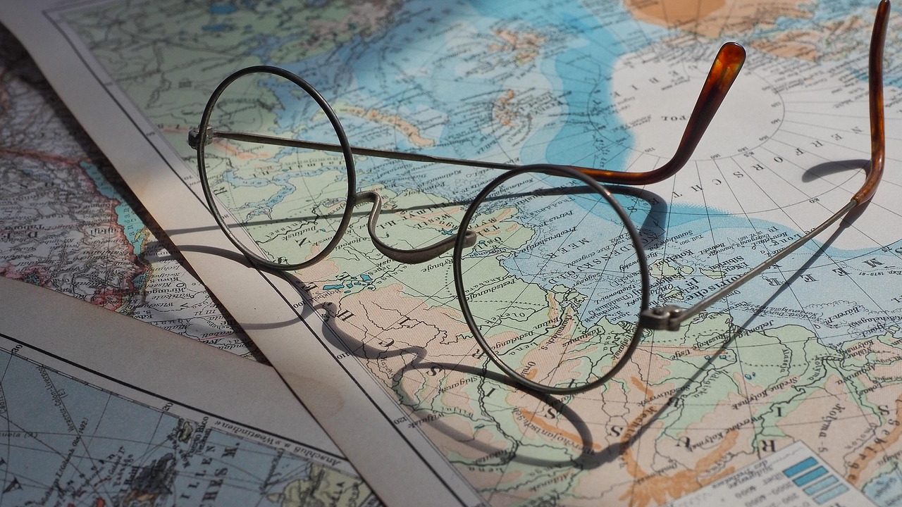 Family members looking at a travel map together at a kitchen table