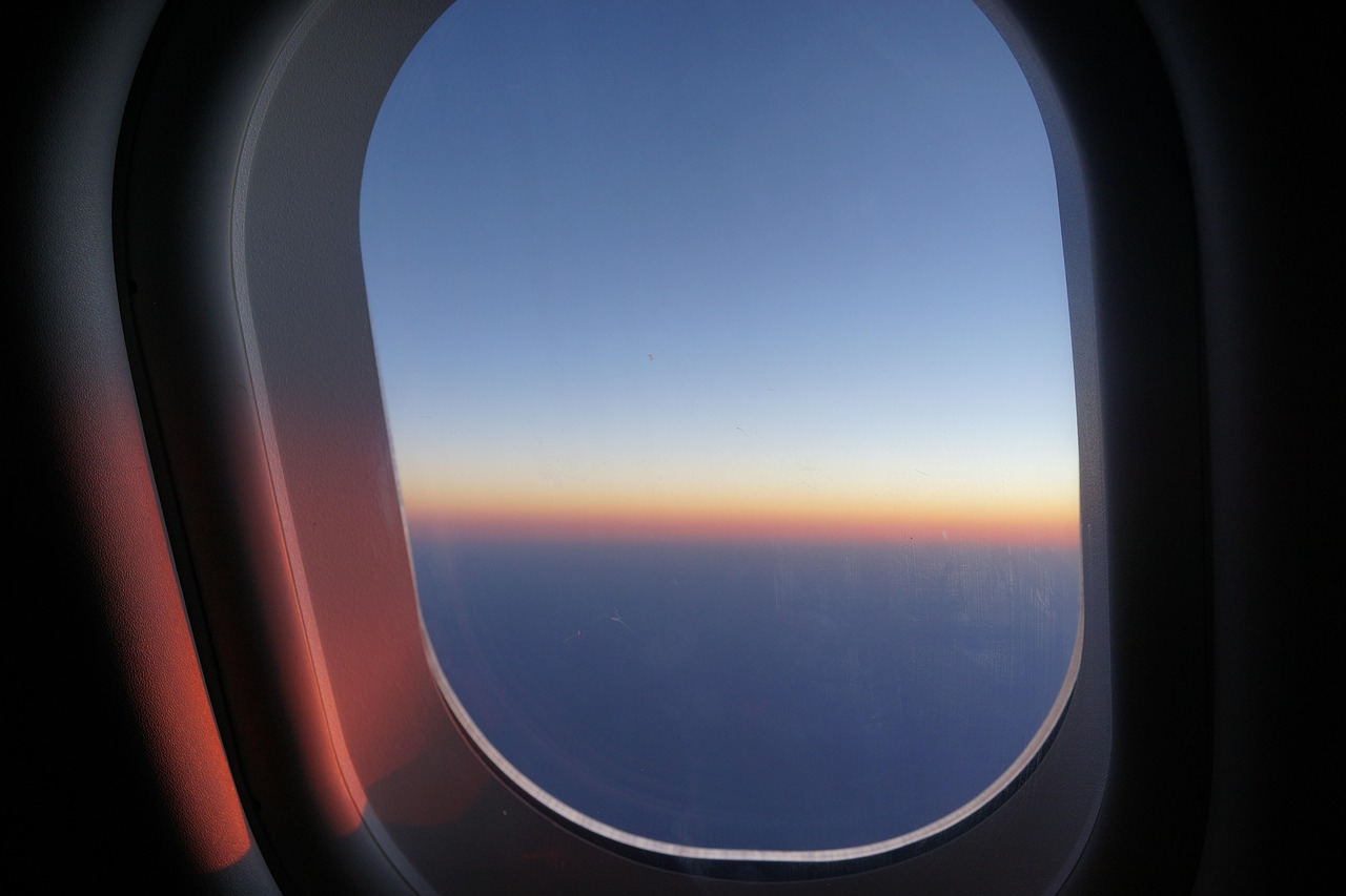 Young child looking out an airplane window